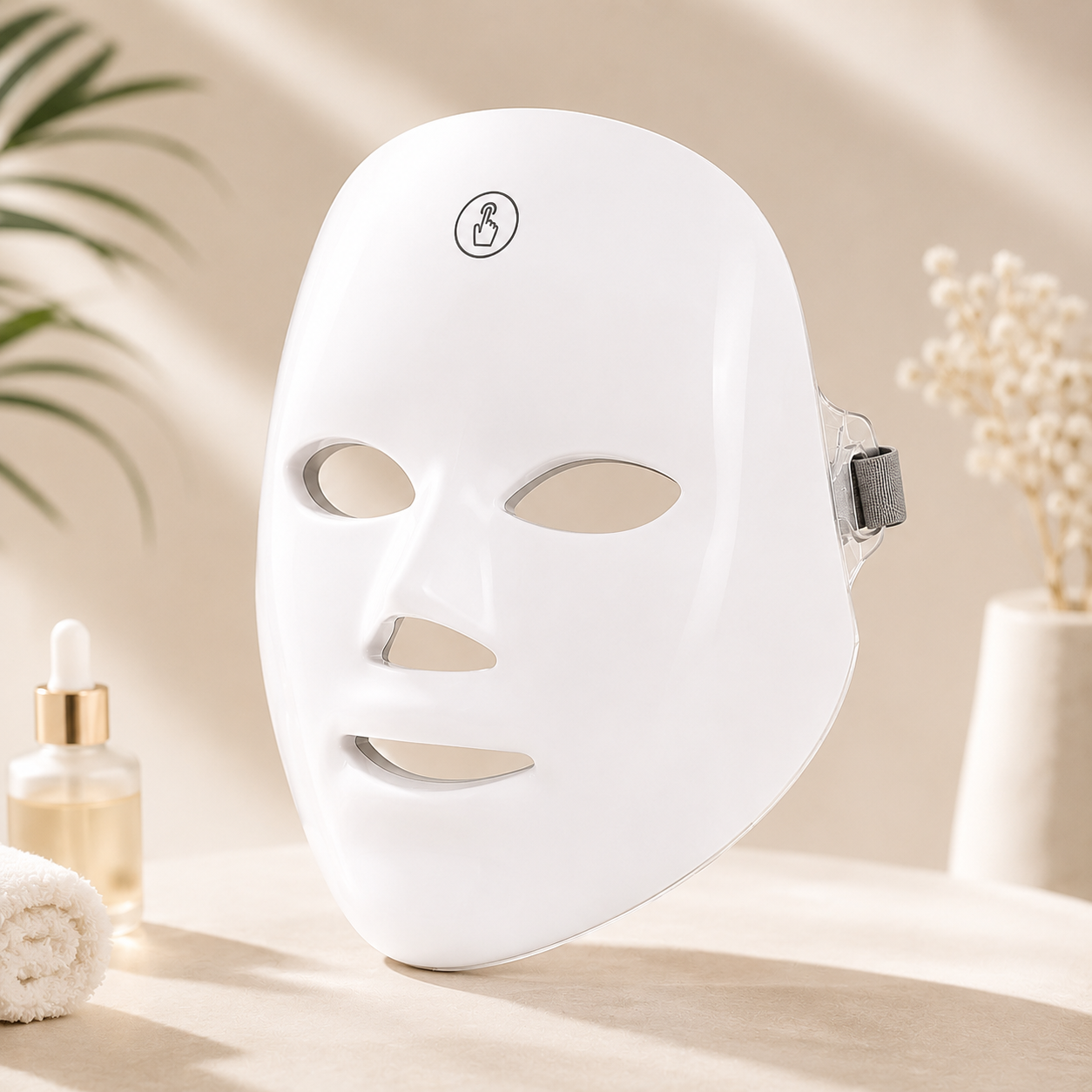 White LED face mask on a neutral background with decorative elements